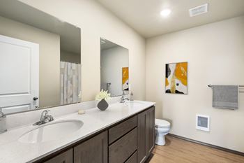a bathroom with a large mirror and a sink and a toilet at Altitude, East Wenatchee, Washington